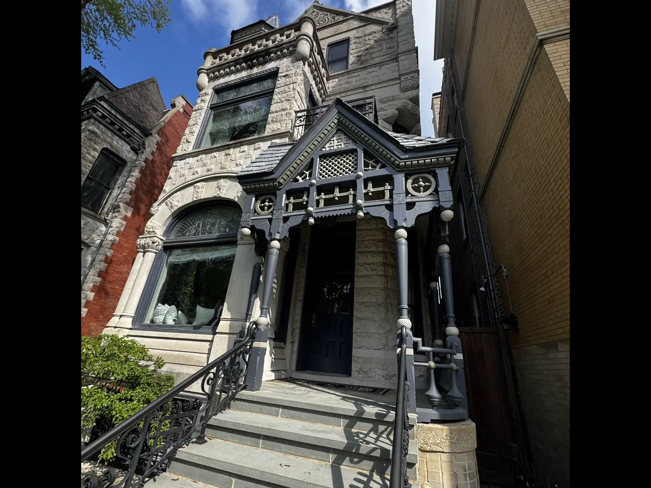 Stone facade of a Chicago greystone home with front steps leading up to the entry
