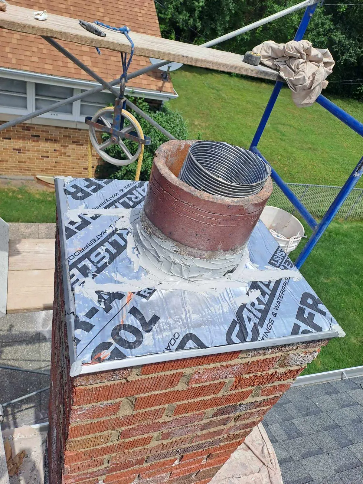 New metal chimney cap with ice and water shield flashing at a Chicago chimney