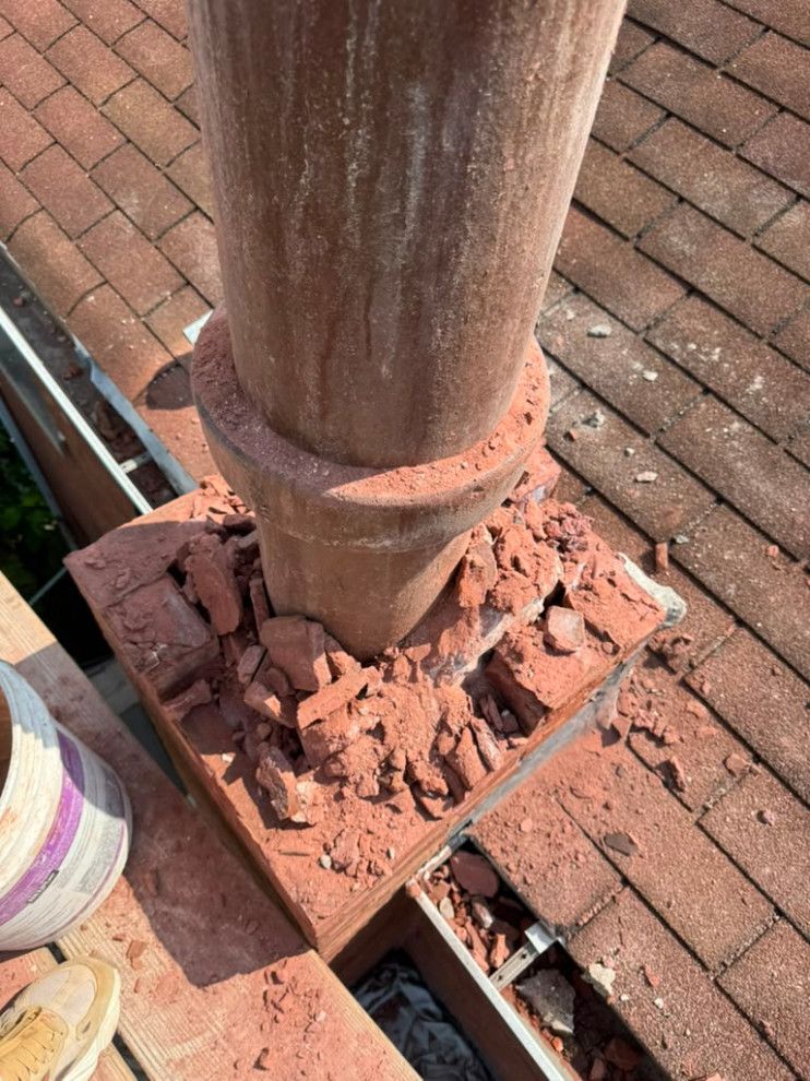 Spalling brickwork around the chimney's clay flue liner before reconstruction