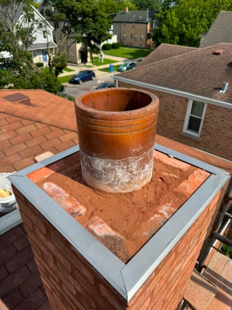 Rebuilt chimney with new flashing around the clay flue liner