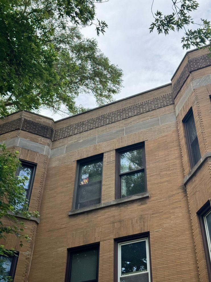 Completed window masonry repair with rebuilt brickwork around the lintels