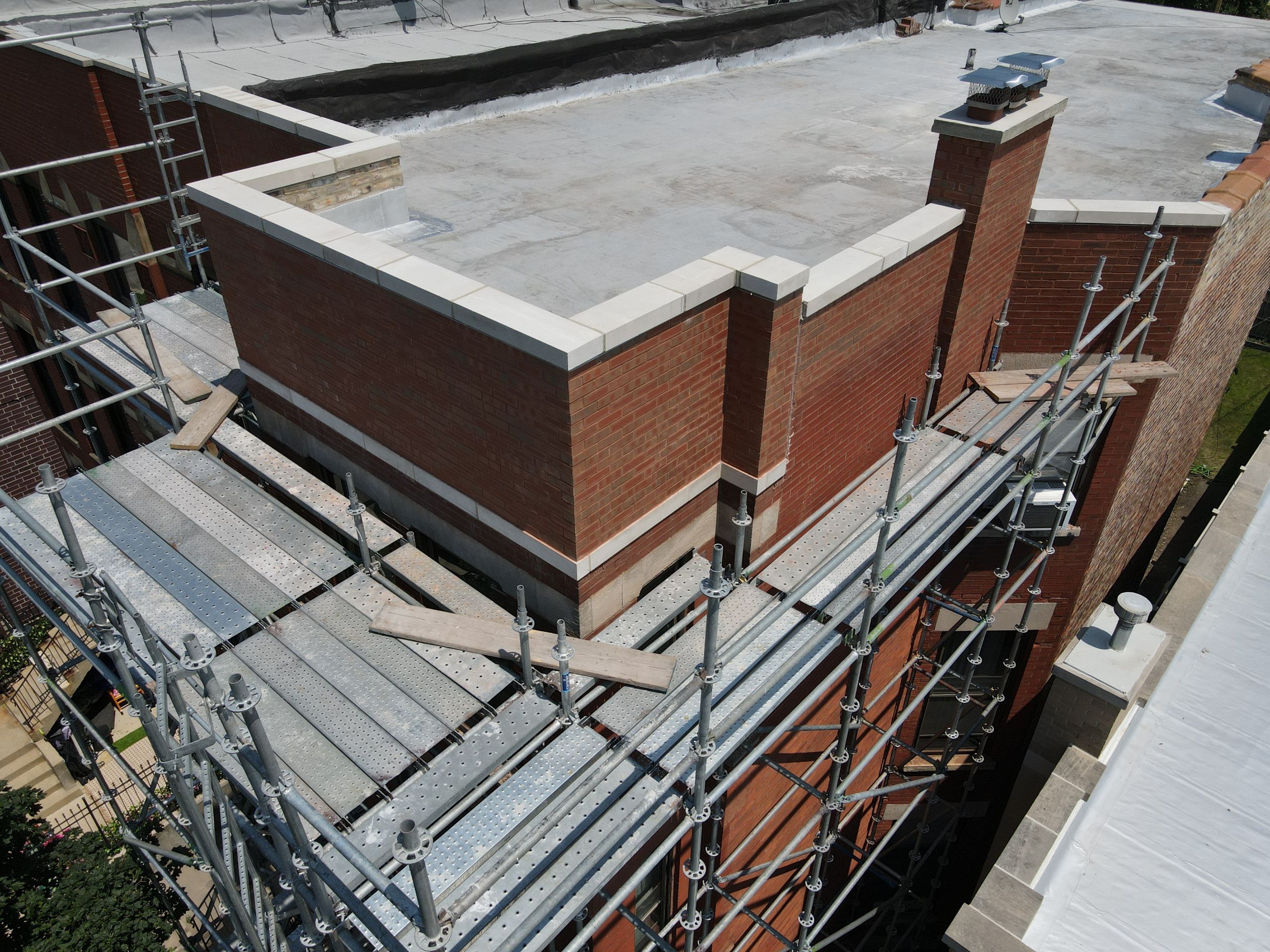 Parapet masonry and roofline during the structural repair