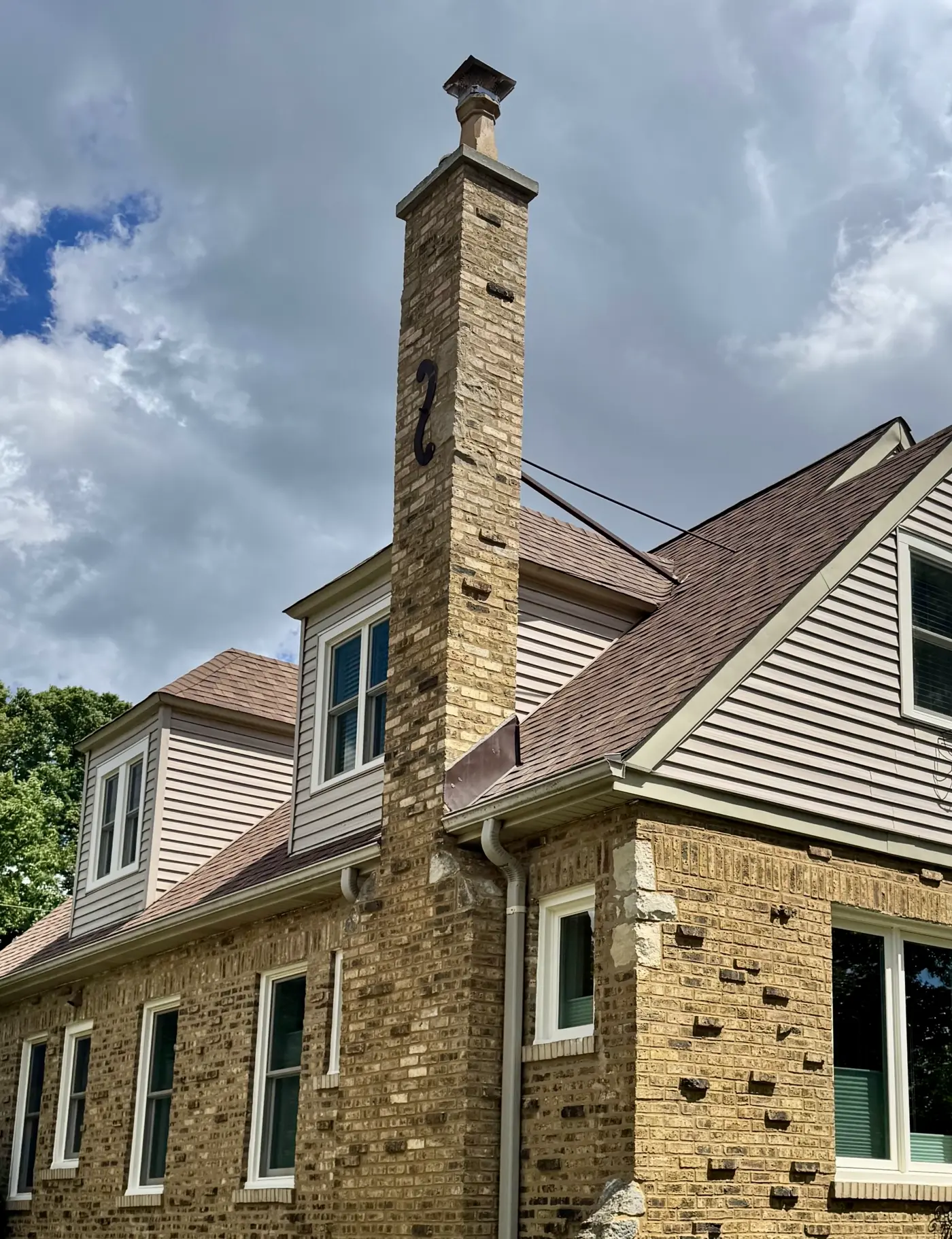 Yellow-brick Chicago bungalow with freshly tuckpointed chimney