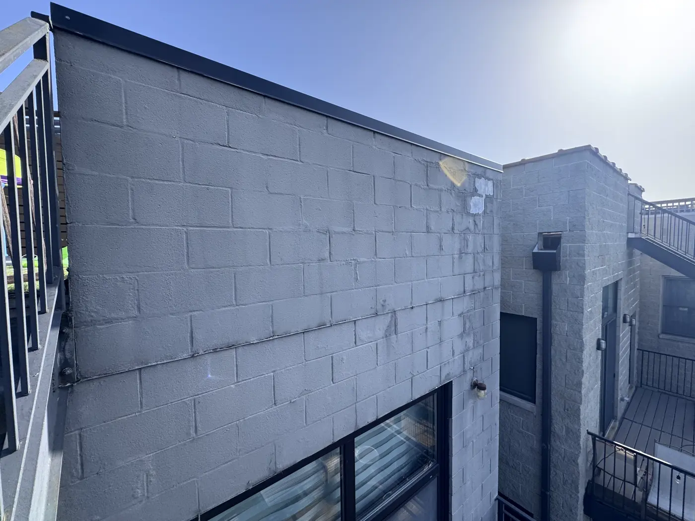 Cinder block wall with visible water staining and efflorescence