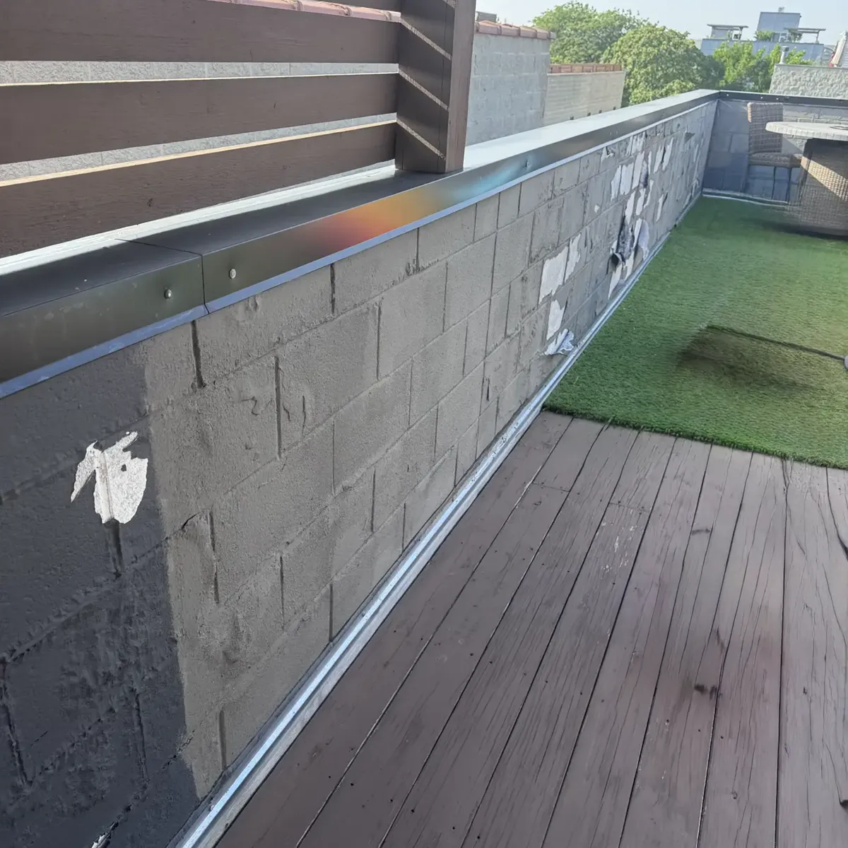 Rooftop cinder block wall protected with breathable masonry sealant
