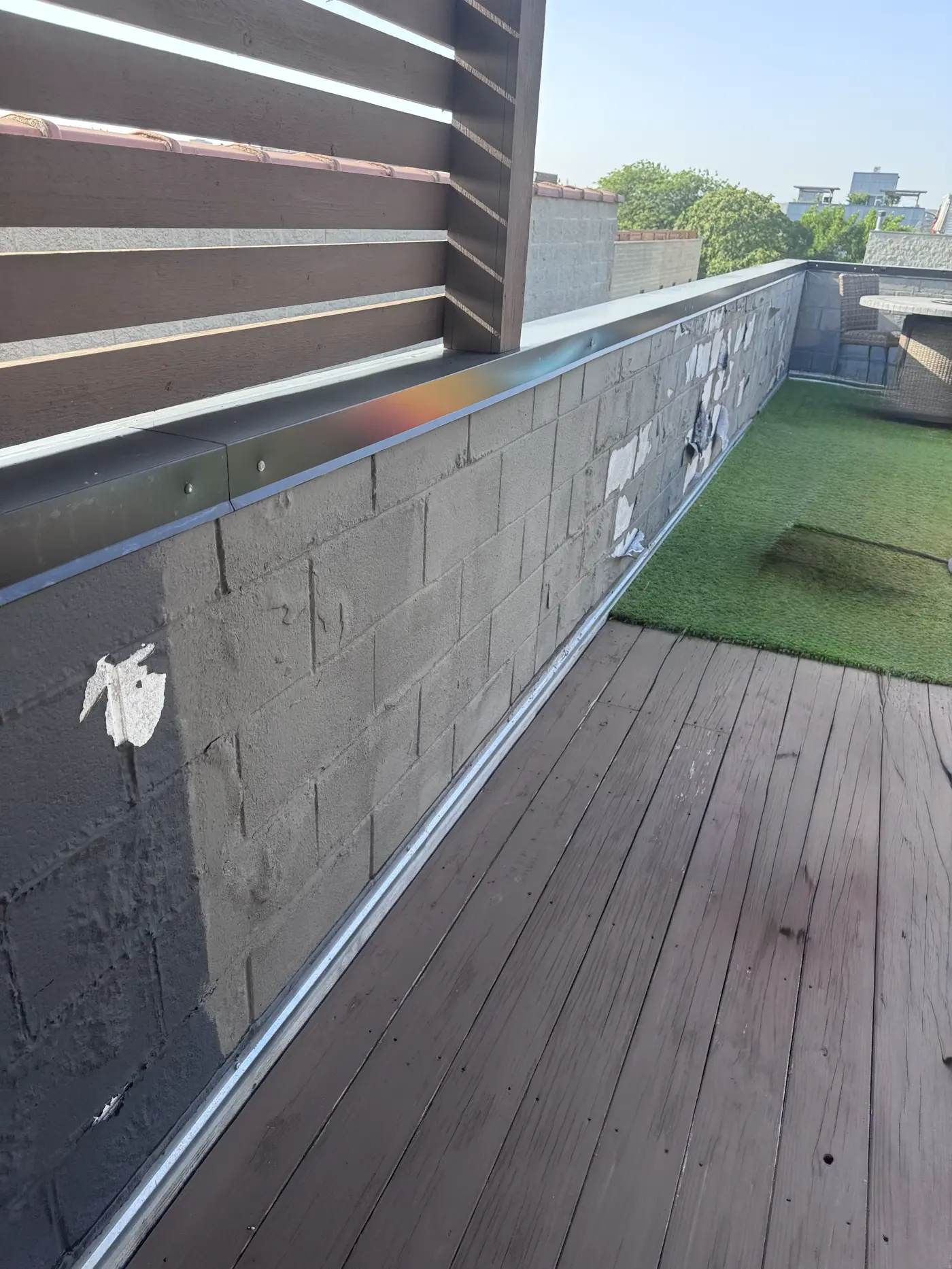 Rooftop cinder block wall protected with breathable masonry sealant